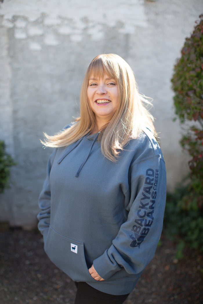 Image of woman smiling wearing Backyard Beans Coffee Co. Hoodie