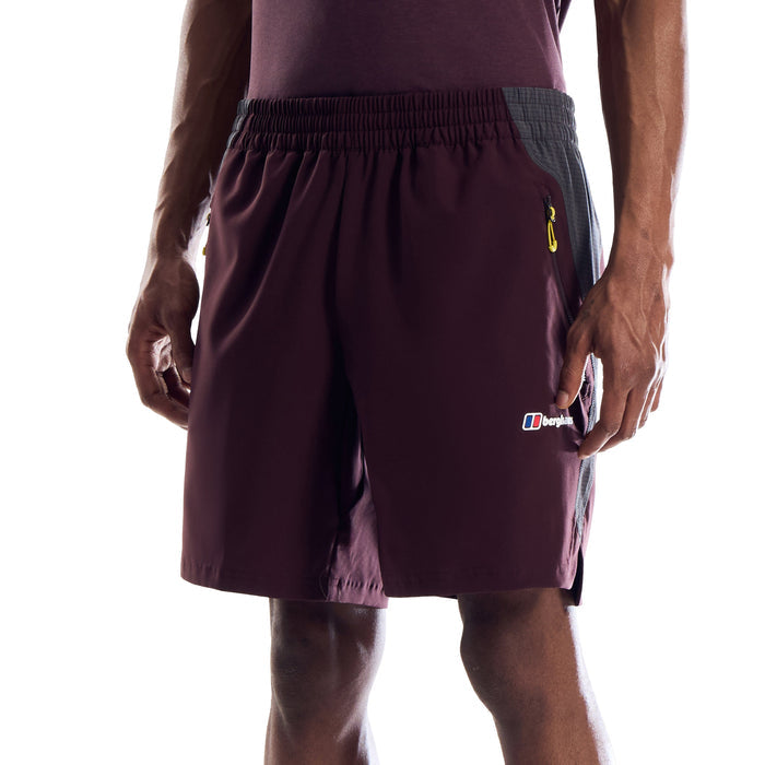 A model from the waist down wearing dark maroon athletic shorts with a gray side panel, black crew socks, and black running shoes, shown against a plain white background.