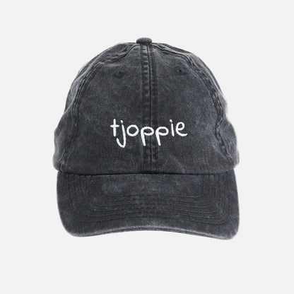 Black cap with 'tjoppie' embroidered on a white background