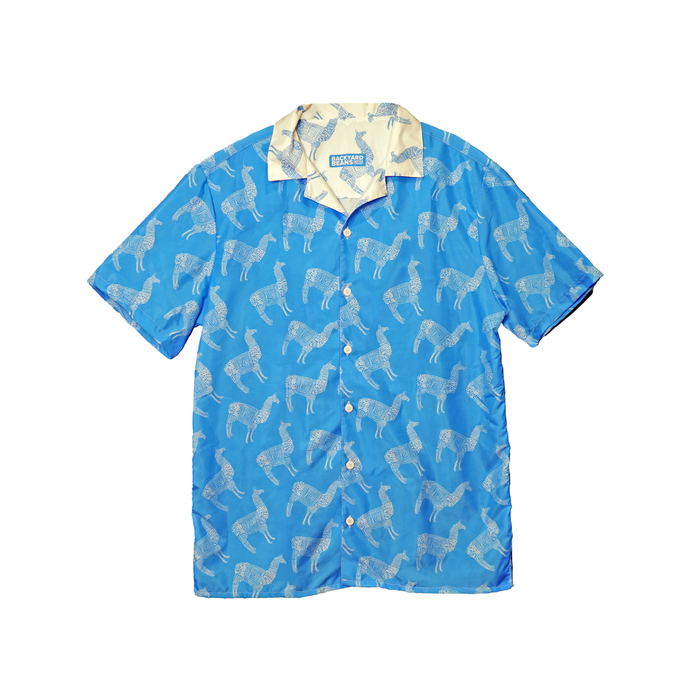 Blue shirt with white llama pattern on a white background