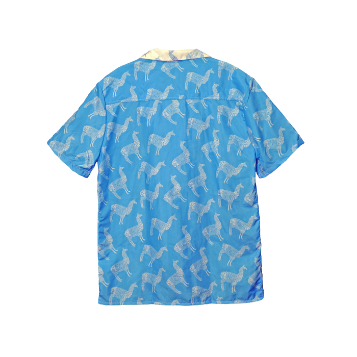 Blue shirt with white llama pattern on a white background