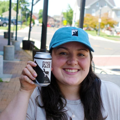 Image of woman and with blue hat and can of Punch cold brew