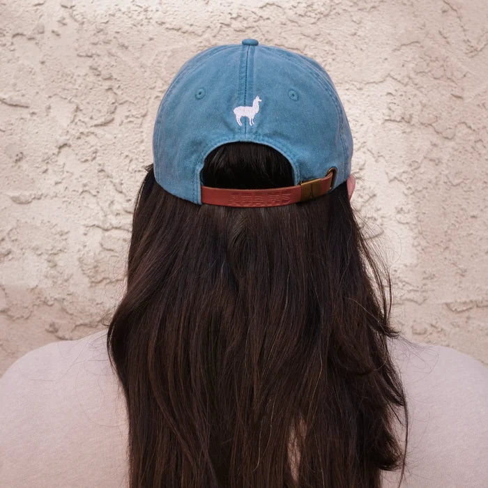 Image of back of blue dad hat with white embroidered llama
