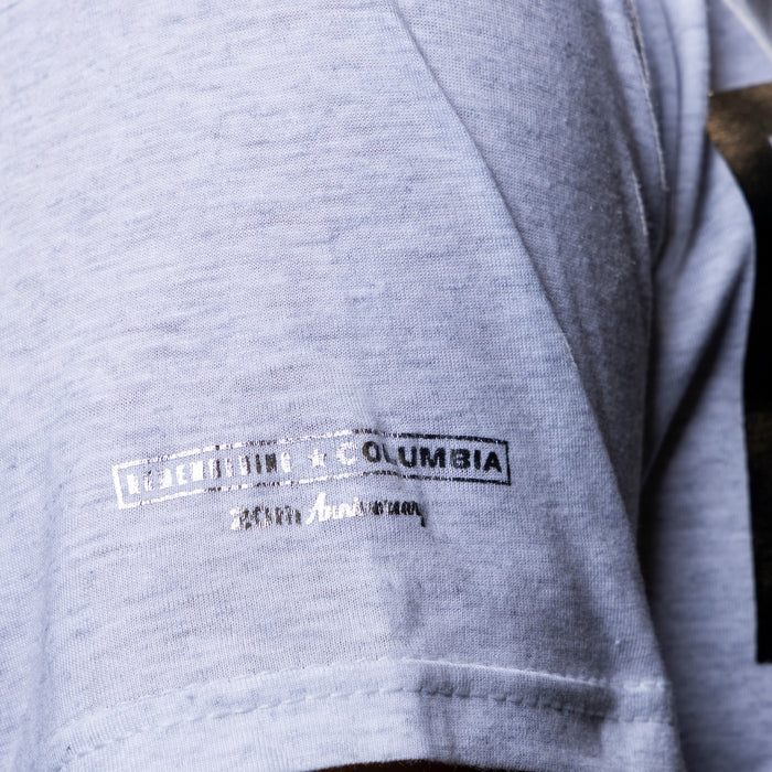 Close-up of a light heather gray t-shirt featuring a distressed black and white 'Remembering Columbia' graphic on the right sleeve
